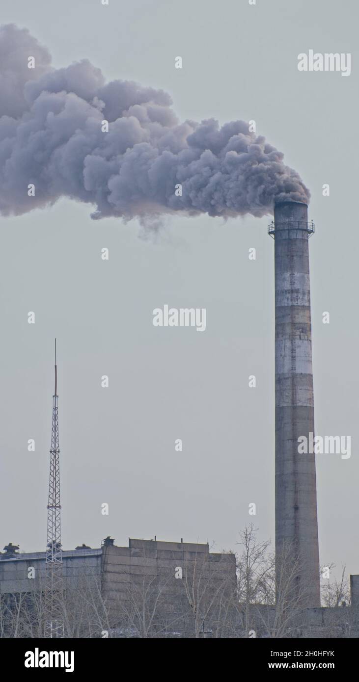 This smoke coming from the chimney in a factory. Harmful emissions into the atmosphere, from the pipe. Serious damage the environment. Stock Photo