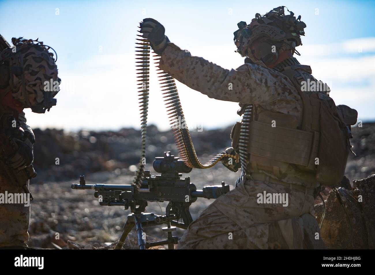 A U.S. Marine with 3rd Battalion, 2d Marine Regiment, 2d Marine Division, attached to 3d Marines, prepares ammunition for an M240B machine gun on Range 400 as part of Service Level Training Exercise 1-22 on Marine Corps Air Ground Combat Center Twentynine Palms, California, Oct.9, 2021. Range 400 provides Marine Corps ground units the opportunity to test and enhance their ability to command and control forces in a contested environment. (U.S. Marine Corps photo by Lance Cpl. Ryan Ramsammy) Stock Photo