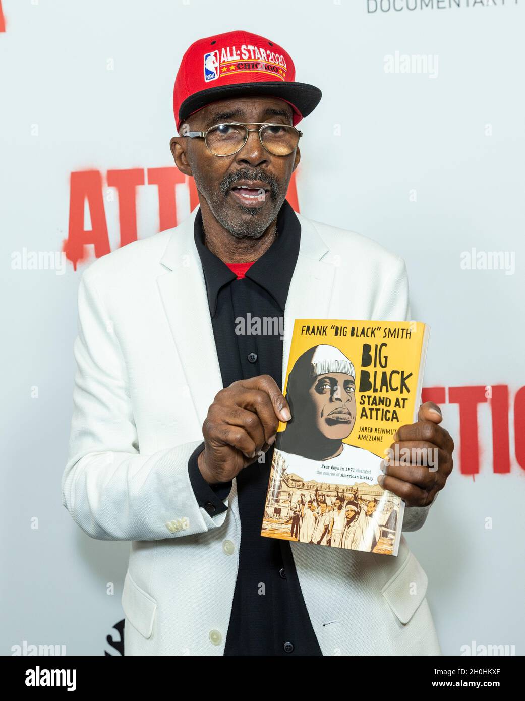 Daniel Sheppard Attica survivor holding book graphic novel memoir from