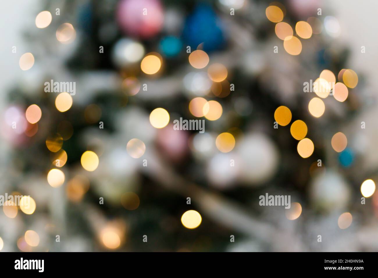 Blurred background with blinking lights of christmas tree. Stock Photo
