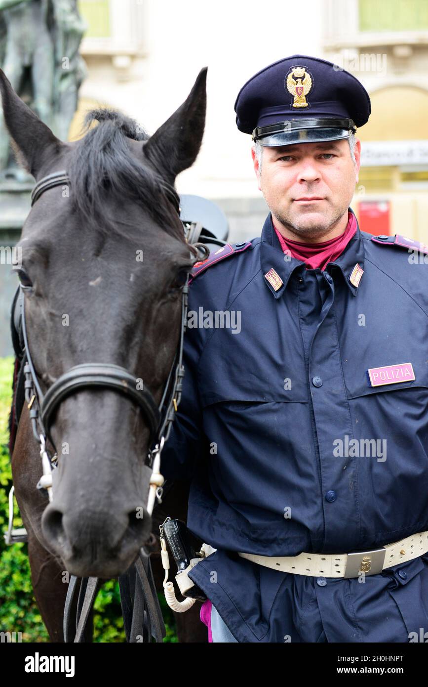 Portrait of a  Sicilian policeman standing next to his horse. Stock Photo
