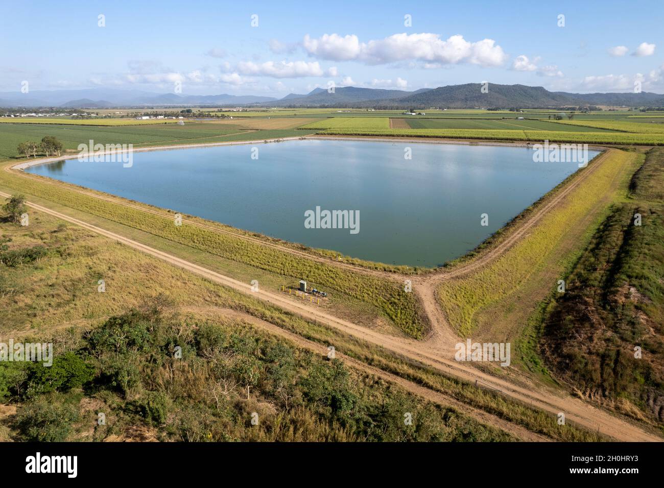 Aerial of a water containment pond pumping from a nearby large dam for