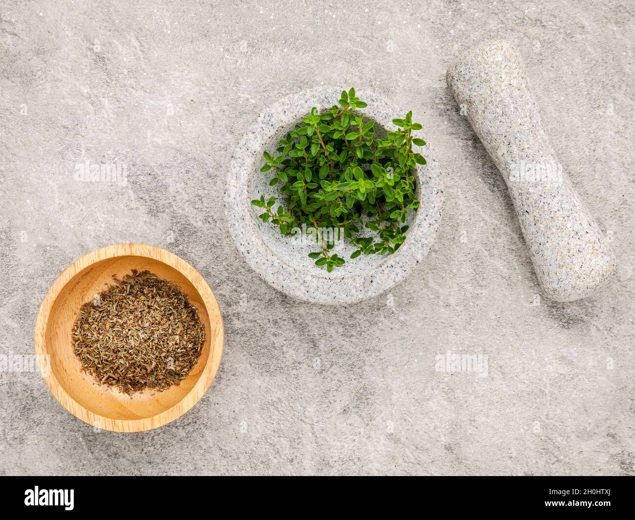 Closeup lemon thyme leaves from the herb garden in white mortar and