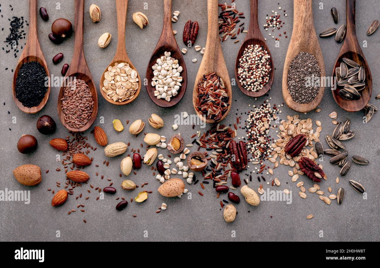 Different types of grains and cereals on shabby concrete background