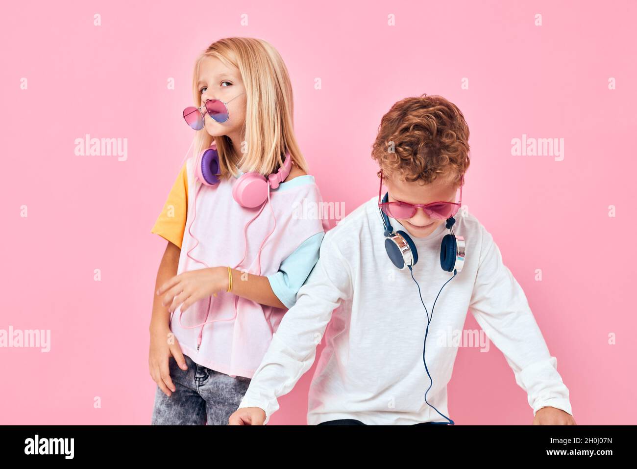 cute smiling kids wearing headphones posing studio posing Stock Photo