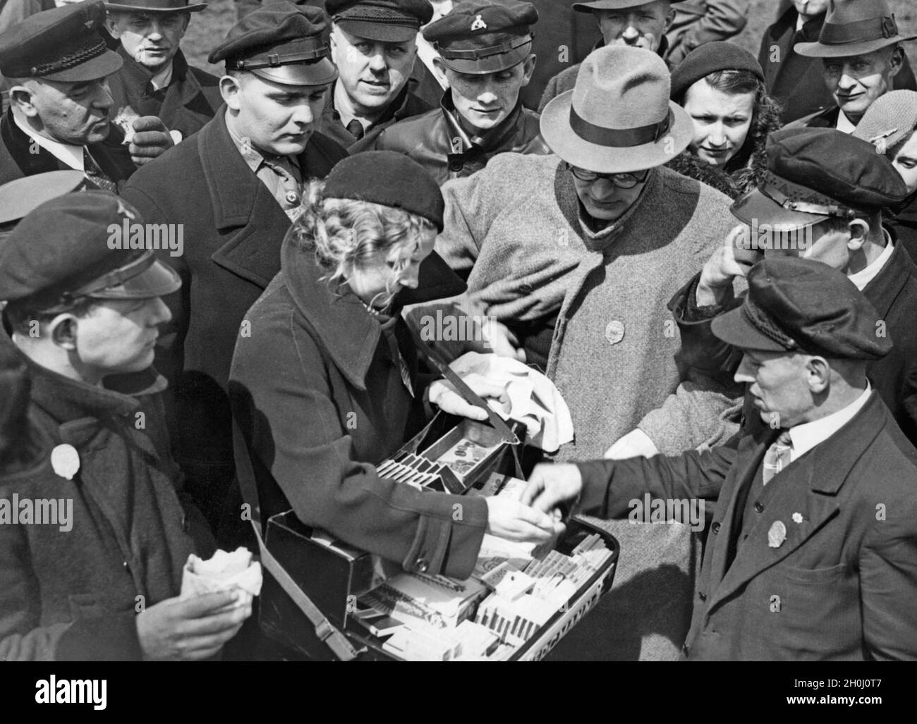 A young woman with a vendor's tray sells cigarettes on 1 May at Tempelhofer Feld in Berlin. (undated photo) [automated translation] Stock Photo