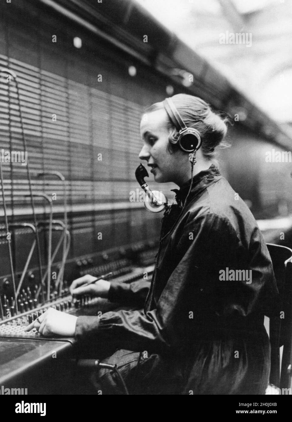 "Employee of a telephone exchange ""reconnecting"" the telephone