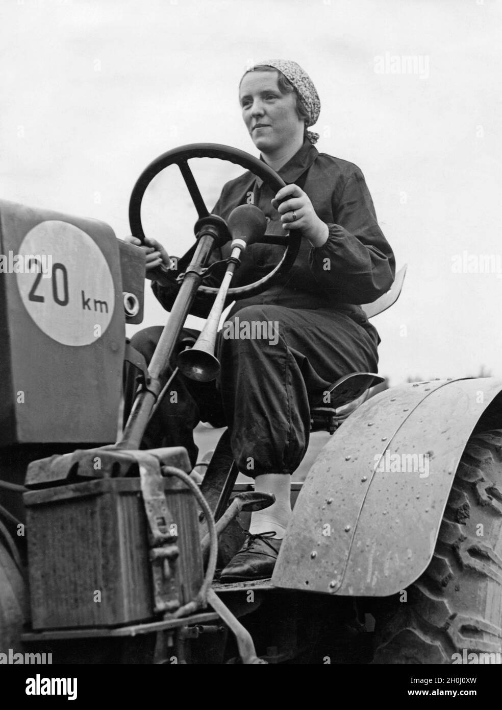 The participant of a course of the tractor driver school Deulakraft in Berlin-Wartenberg at the wheel of a tractor. [automated translation] Stock Photo