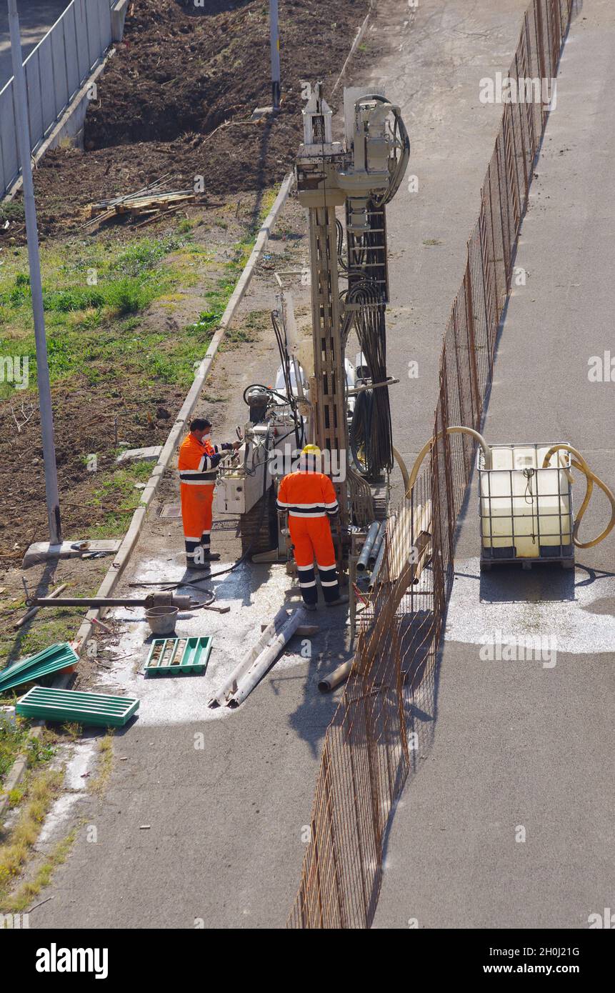 Workers in high visibility work overalls near an auge Stock Photo