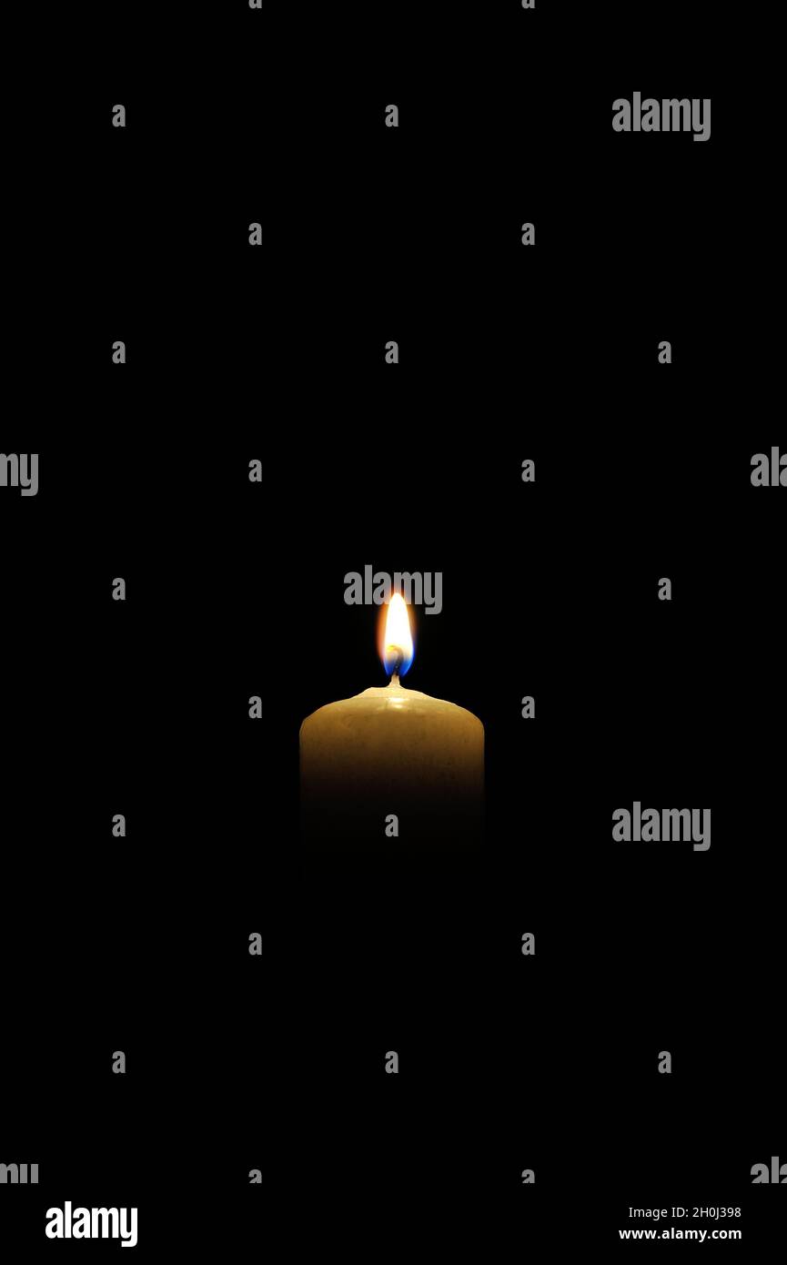 Burning candle on black background Stock Photo - Alamy