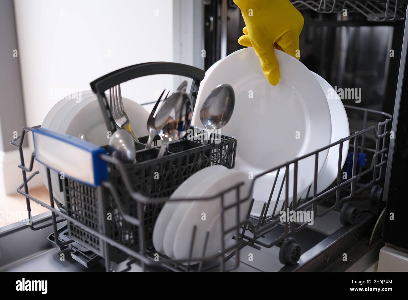 Complete dishwasher with clean washed dishes closeup Stock Photo Alamy