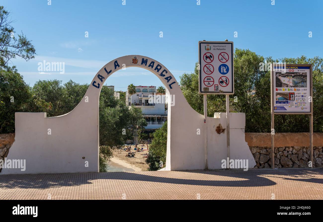 Portocolom, Spain; october 05 2021: Main entrance and the information panel, with all the information logos of Cala Marsal beach, with the beach in th Stock Photo