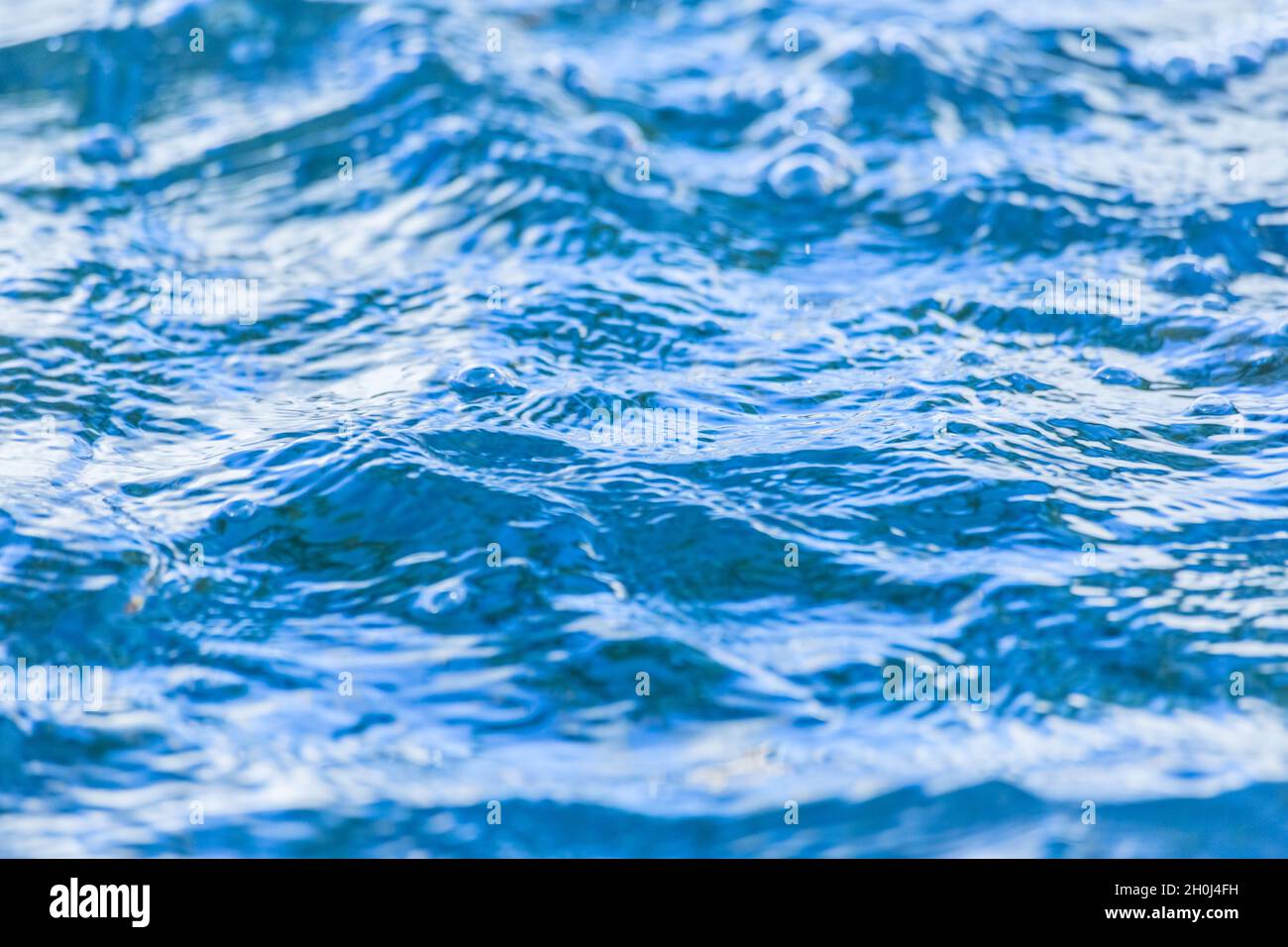 The bright blue waves on a water surface Stock Photo - Alamy