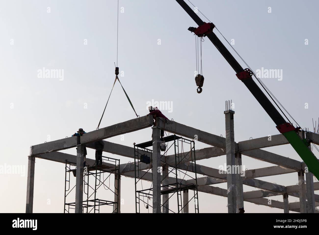 precast concrete beam installed at construction site by mobile crane