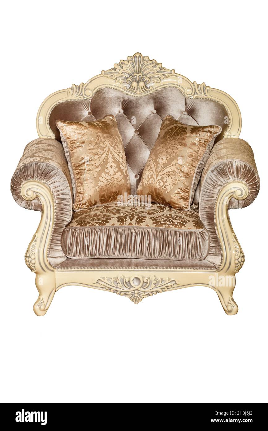 Luxurious soft armchair upholstered in expensive beige brocade and velor fabric, isolated on a white background. Stock Photo