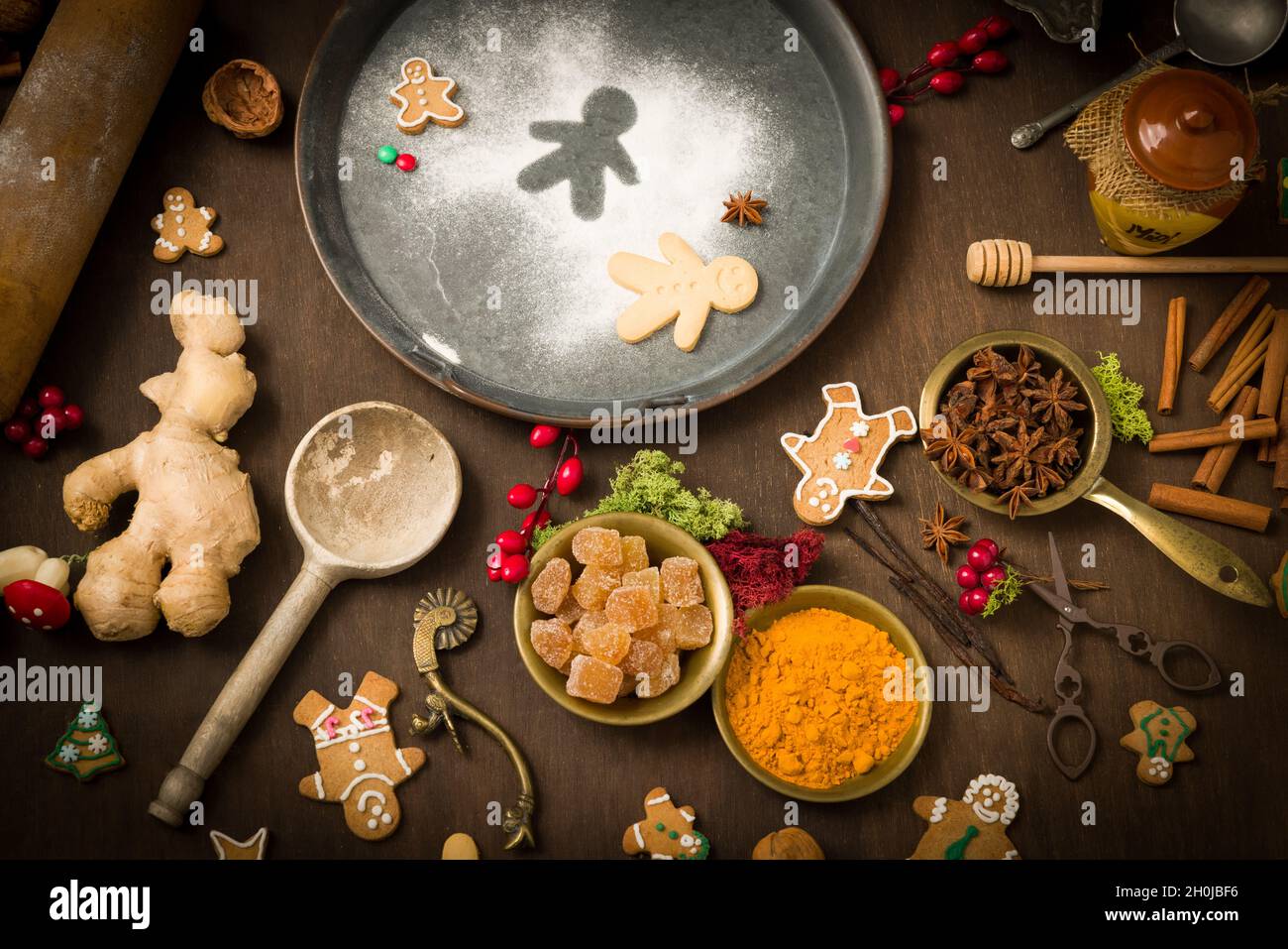 Vintage still life of Christmas gingerbread cookies and their ingredients arranged in a colourful circle Stock Photo