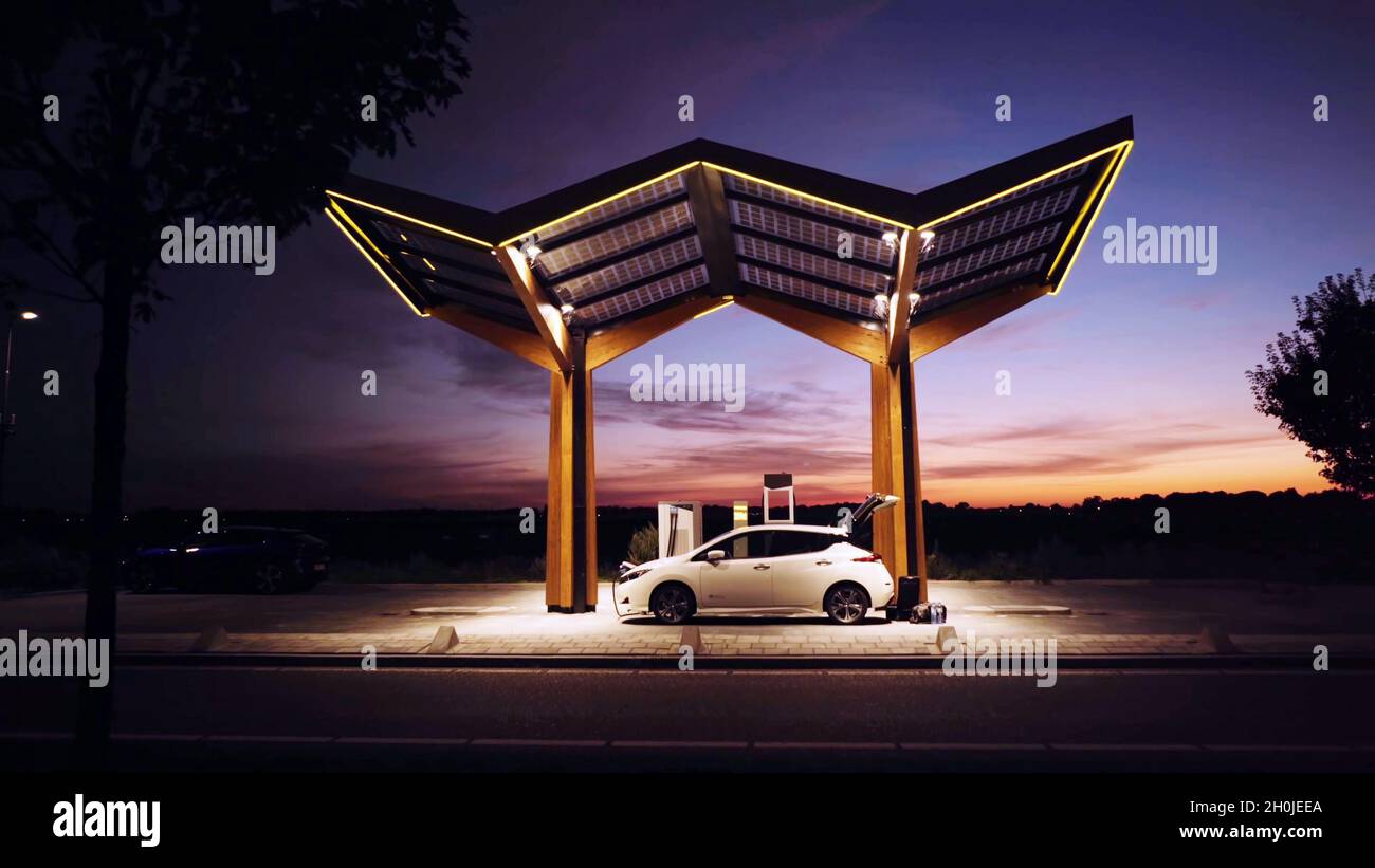 White Electric Car Charging The Battery In An Electric Charging Station 