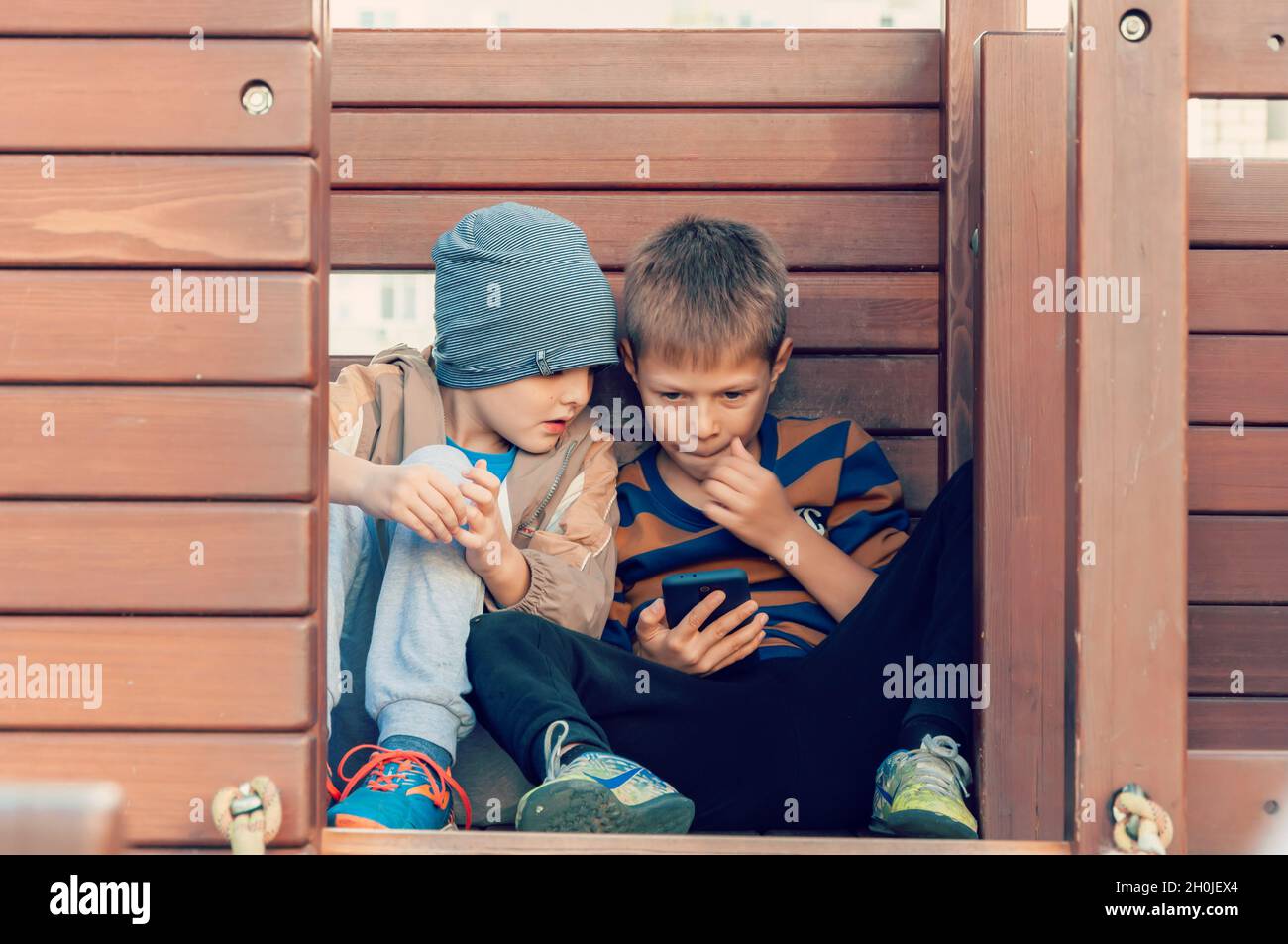 Krasnodar, Russia - October 9 2021: Boys spending time in a social network using mobile phones. Stock Photo
