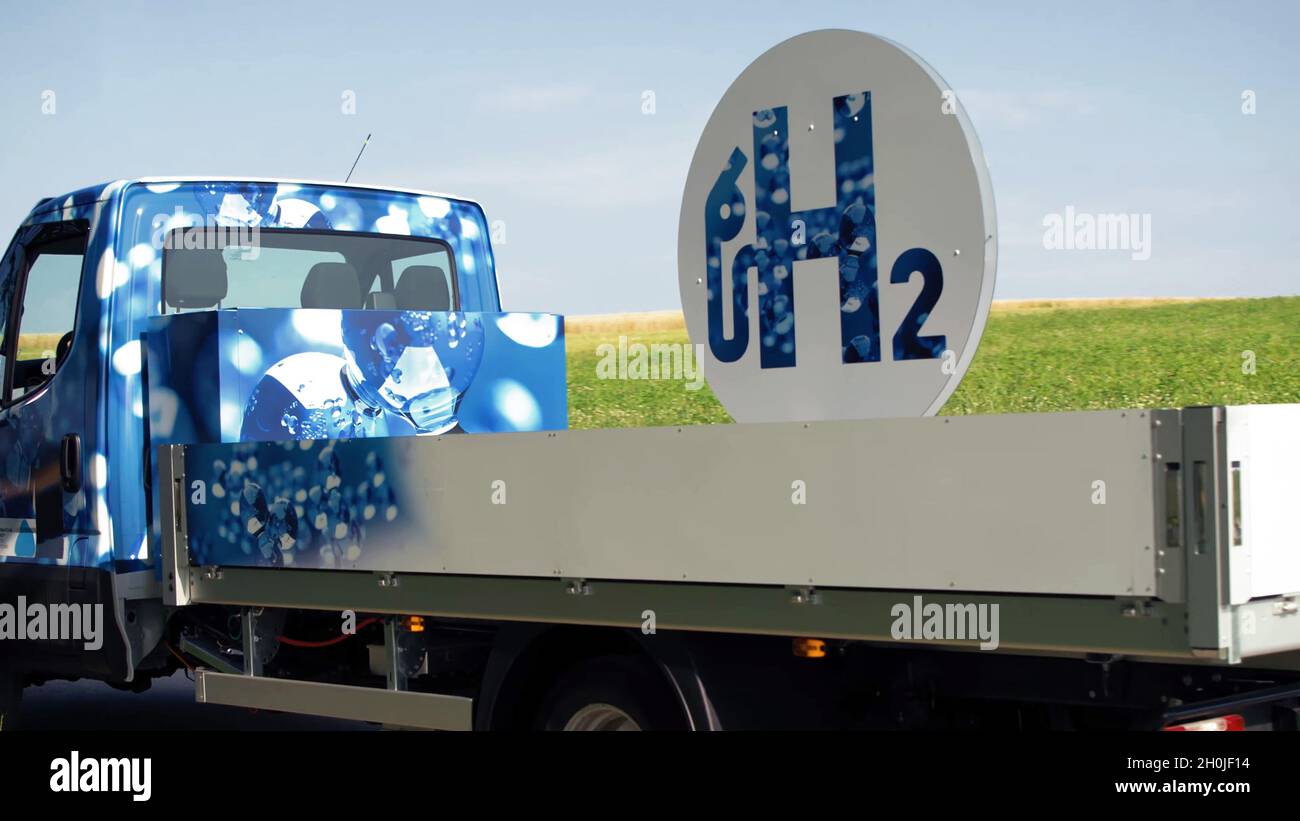 Closeup of a white hydrogen fuel cell car or van driving on the