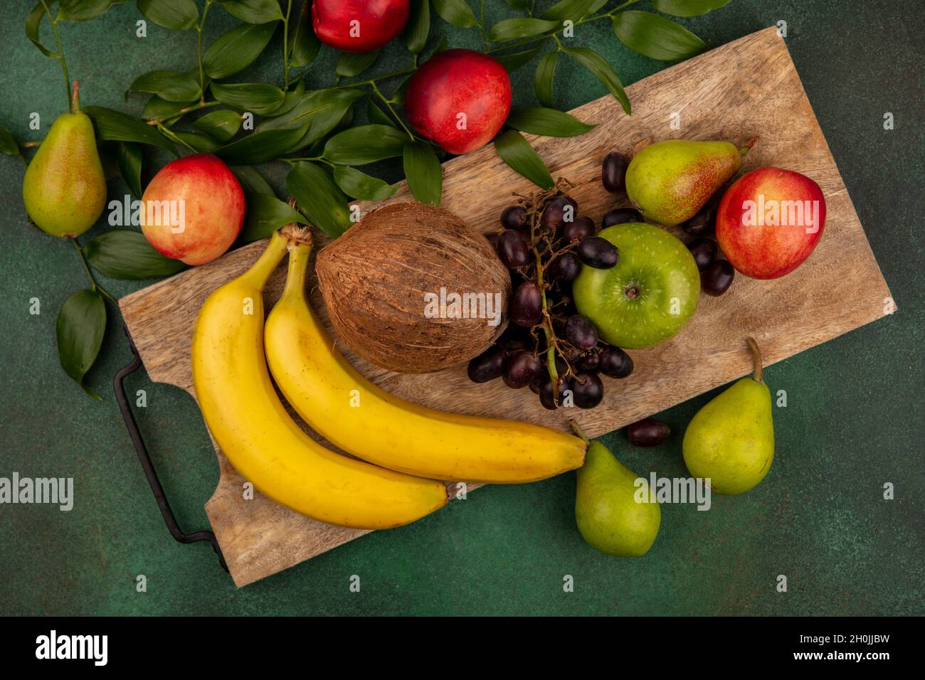 top view of fruits as grape peach pear apple banana coconut on cutting