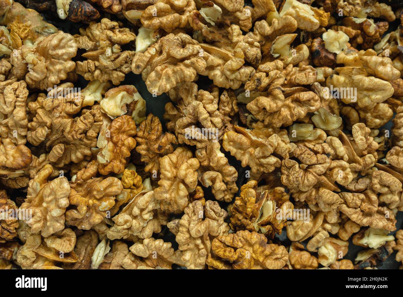 Background from a pile of peeled walnut halves. Top view. Close-up Stock Photo