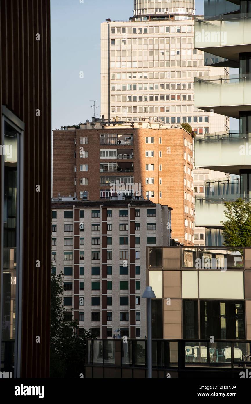 Italy, Lombardy, Milan, skyscraper and house buiding from Alvar Aalto square Stock Photo