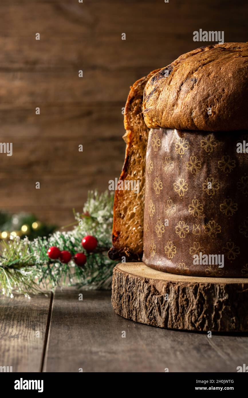 Traditional Italian panettone for Christmas on rustic wooden table Stock Photo