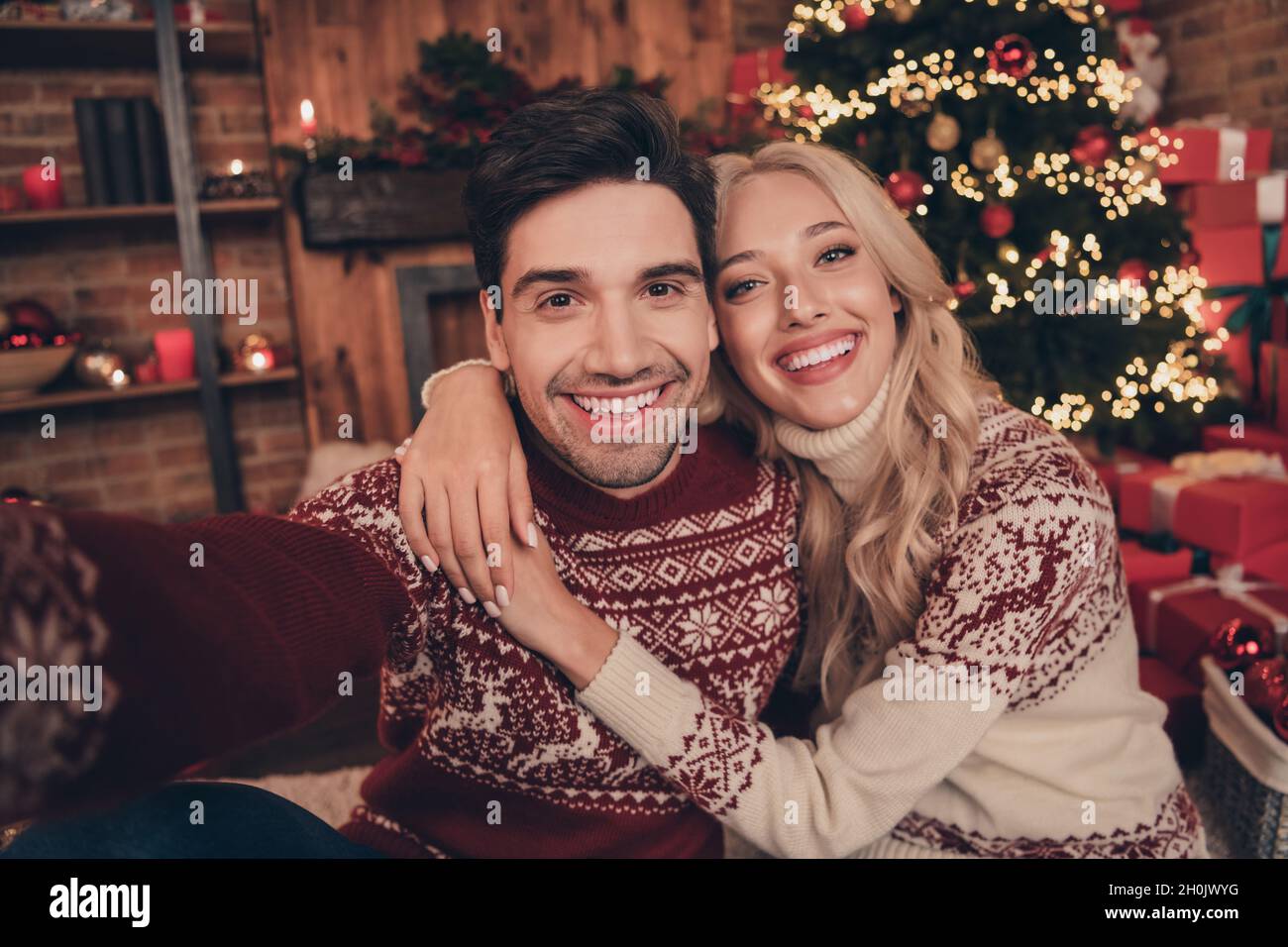 Photo of funky couple do selfie hug wear ugly new year jumpers indoors ...