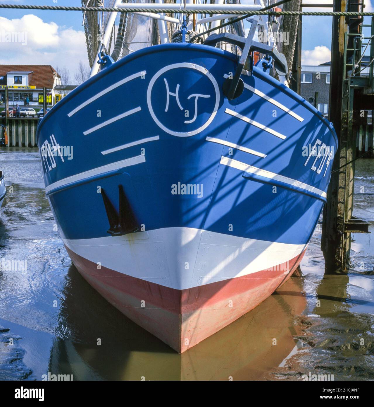 Red shrimp boat at the pier of Fedderwardersiel, Germany, Lower Saxony, Fedderwardersiel Stock Photo