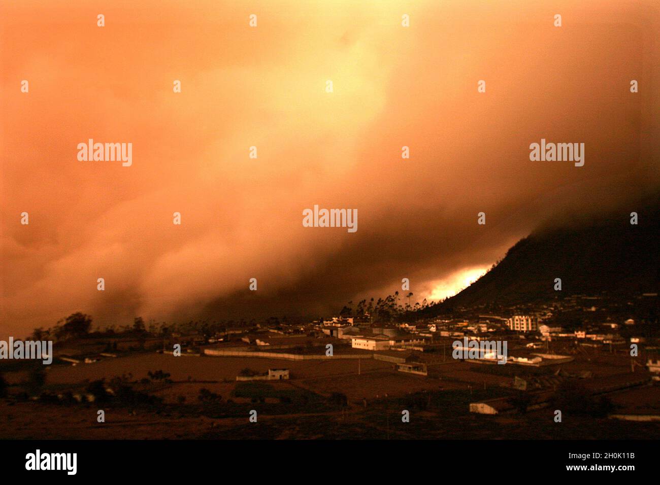 The ‘Tungurahua’, an active volcano, in the ‘Cordillera Central’ (a chain of mountains, in the Andes) of Ecuador, erupted on July 14th and August 16th of 2006, devastating life in the small towns on its slope and surroundings. A “river of fire” was formed by over 10 million cubic meters of ash, gravel and incandescent material. More than 3000 people were evacuated from the area with six casualties and around 60 missing. With the alarm of another eruption ahead, the residents enter the emergency zone to work and take care of their homes. By nightfall they return to rest at the volcano’s feet. T Stock Photo