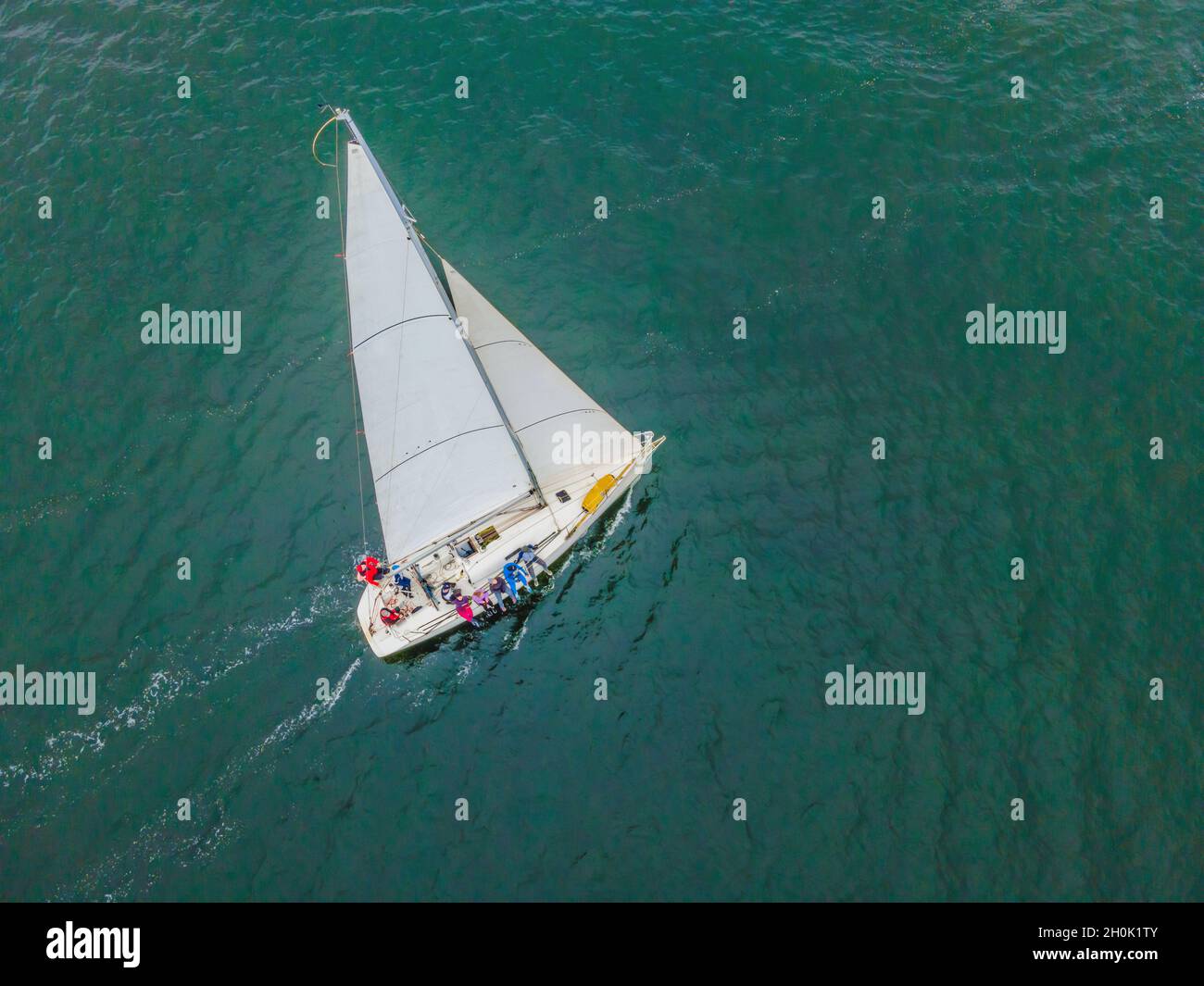 Aerial bird's eye view photo taken by drone of sailboat in turquoise ...