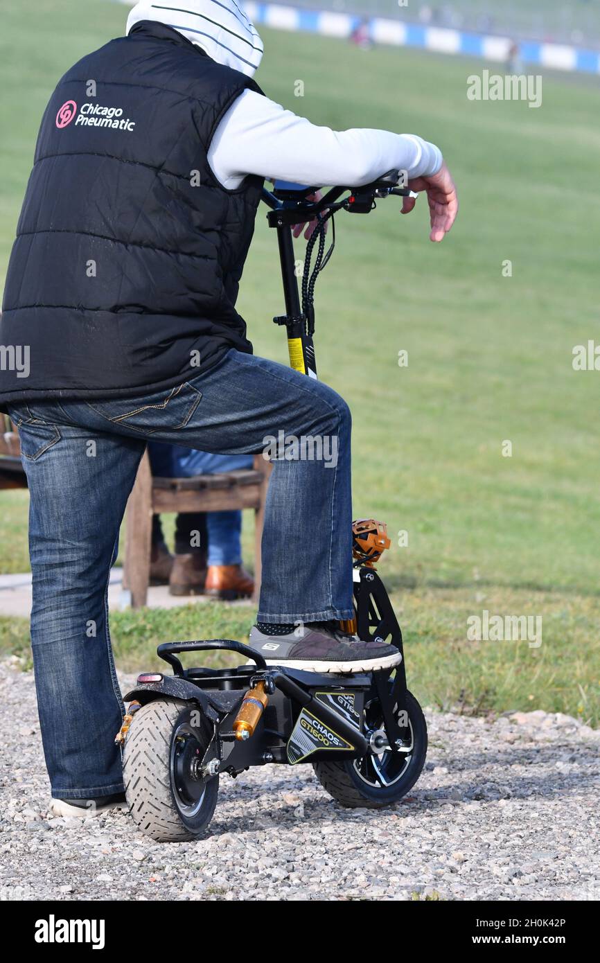 A male taking a break from riding their e-scooter Stock Photo