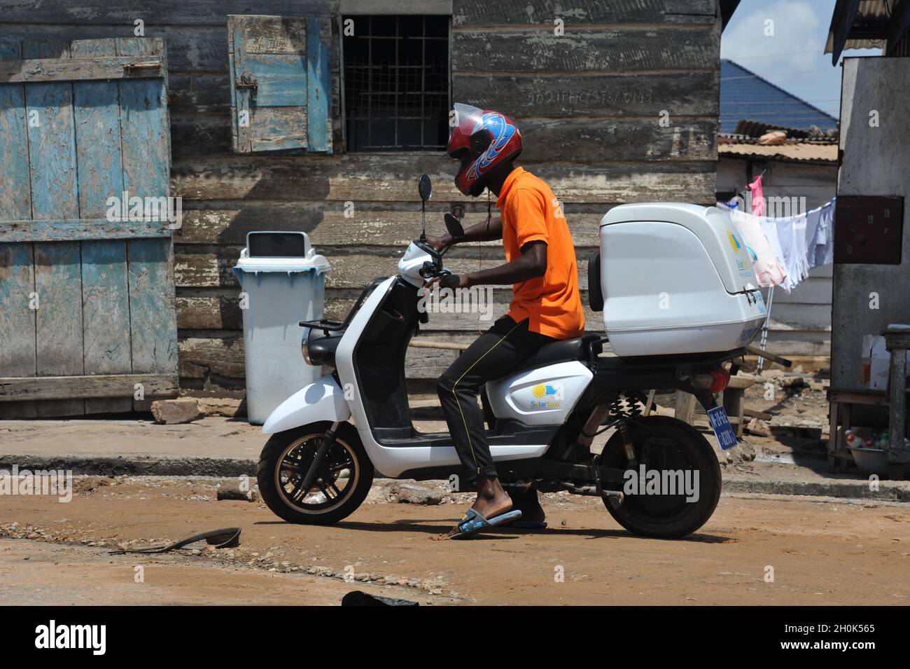 Accra, Ghana. 8th Oct, 2021. A staff member takes a test ride on an