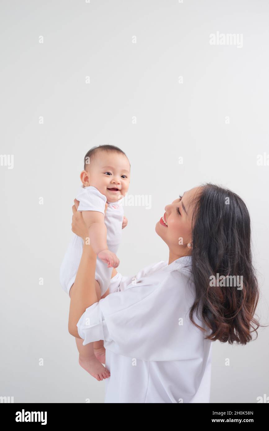 Safe in his mother's arms. Mother and her baby girl at home Stock Photo Alamy