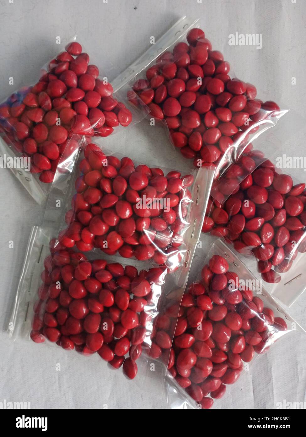 red saga seeds in small bag Stock Photo