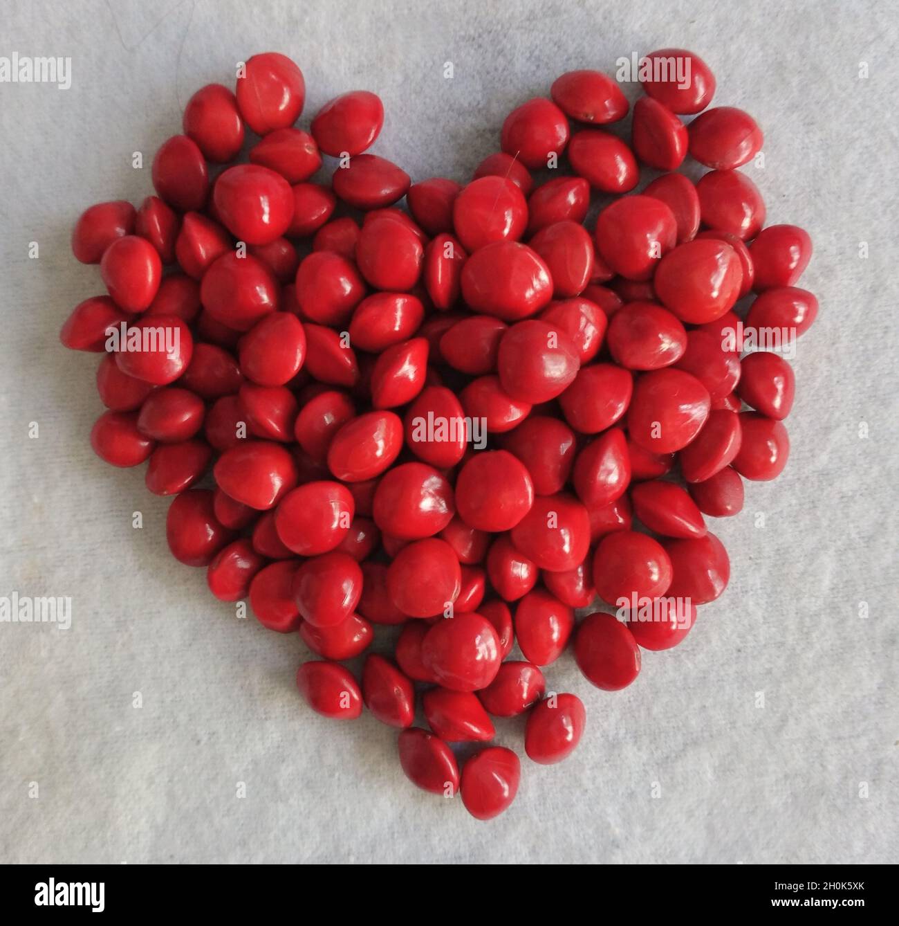 red heart shape saga seeds background border Stock Photo