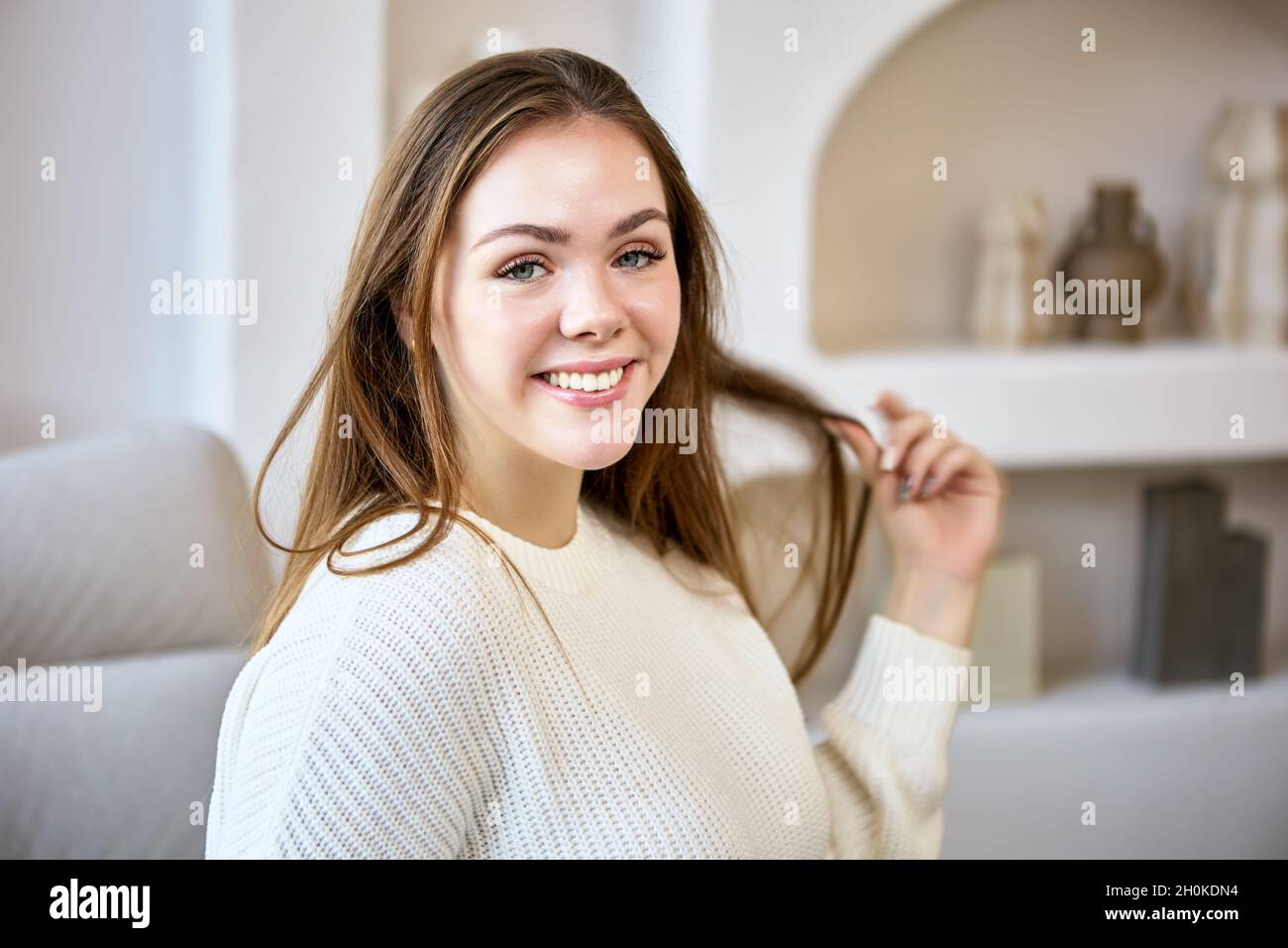 Portrait of cheerful caucasian woman on sofa indoors Stock Photo - Alamy