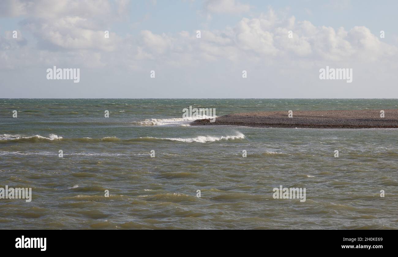 Waves rolling over gently near the shore. Stock Photo