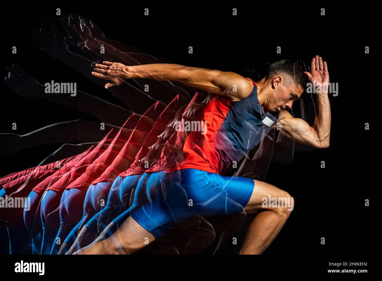 Cropped portrait of young athletic man, professional runner isolated over black background. Stroboscope effect. Stock Photo