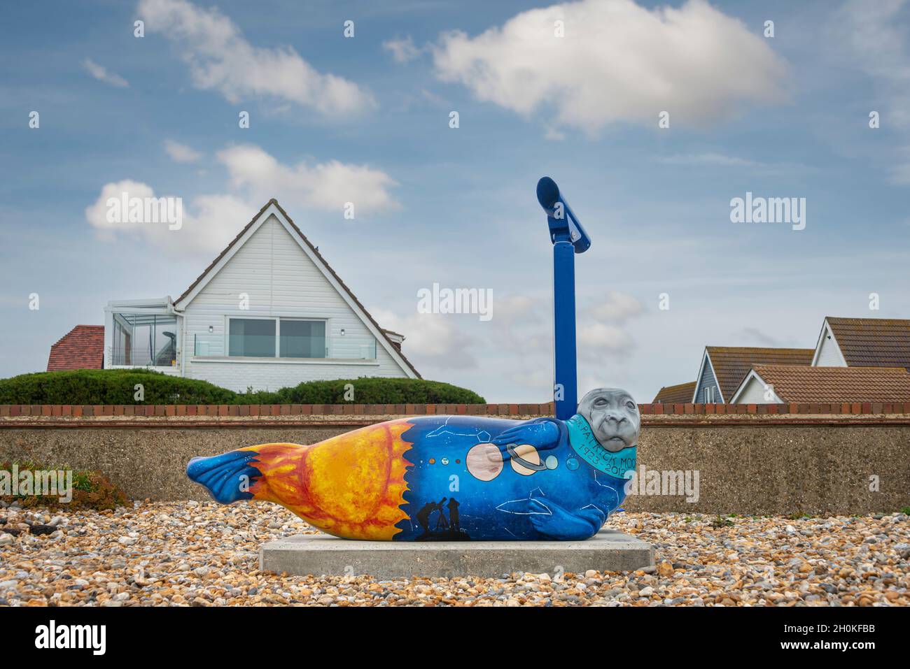 Colourful painted seal sculpture on the beach at Selsey, West Sussex, in memory of astronomer Sir Patrick Moore who lived there. Stock Photo