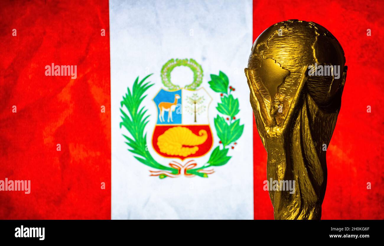 October 6, 2021 Lima, Peru. FIFA World Cup Cup against the background of the flag of Peru. Stock Photo