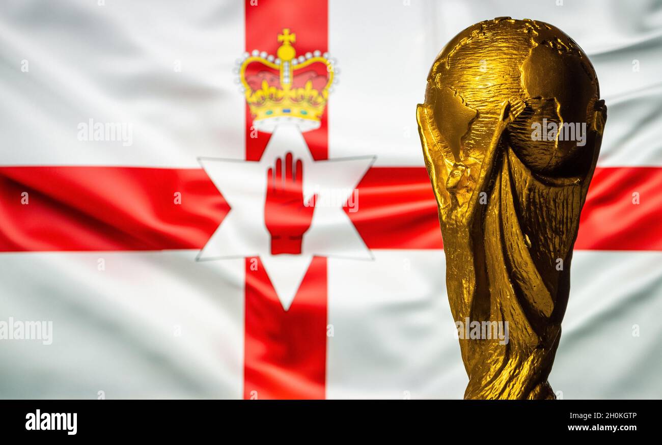 October 6, 2021 Belfast, Northern Ireland. FIFA World Cup Cup against the background of the flag of Northern Ireland. Stock Photo