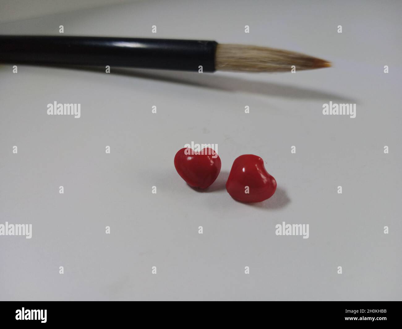 china brush with red heart shape saga seeds Stock Photo