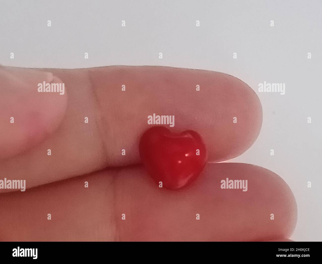 hand hold red heart shape saga seeds Stock Photo