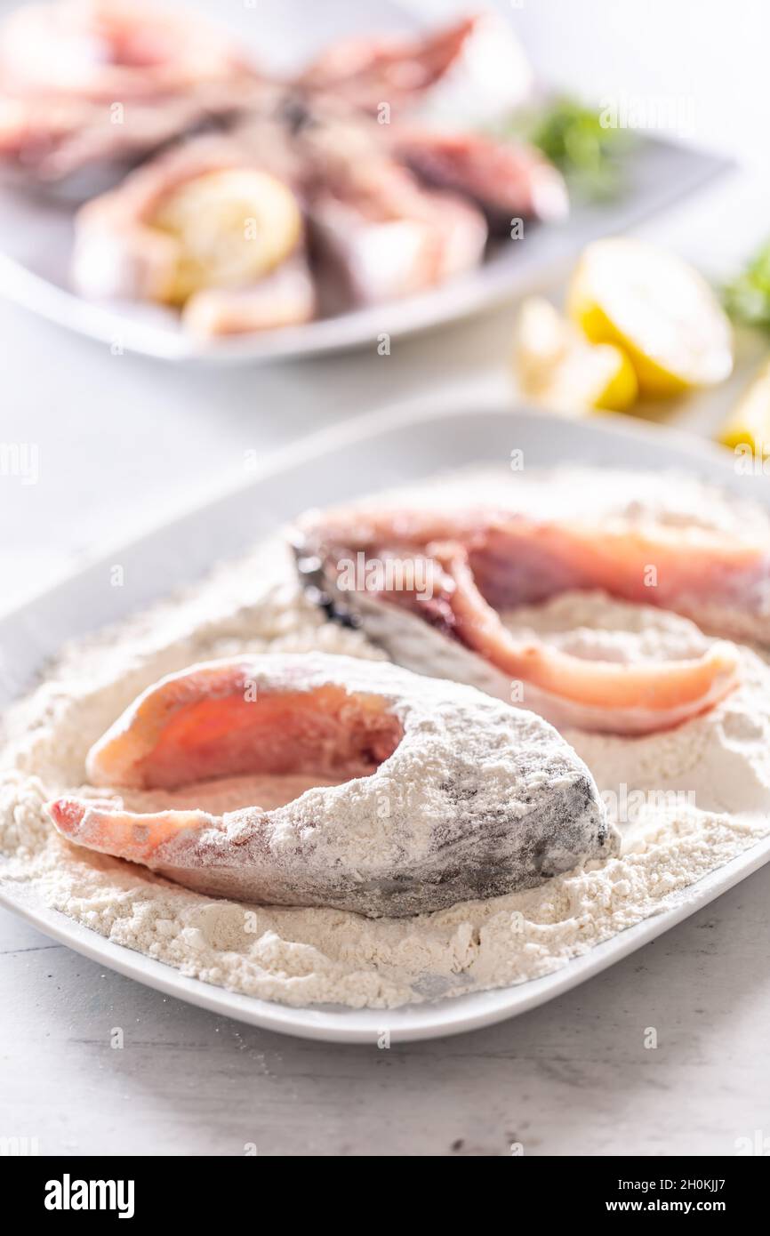 Preparation of fresh fish before frying by wrapping in flour Stock