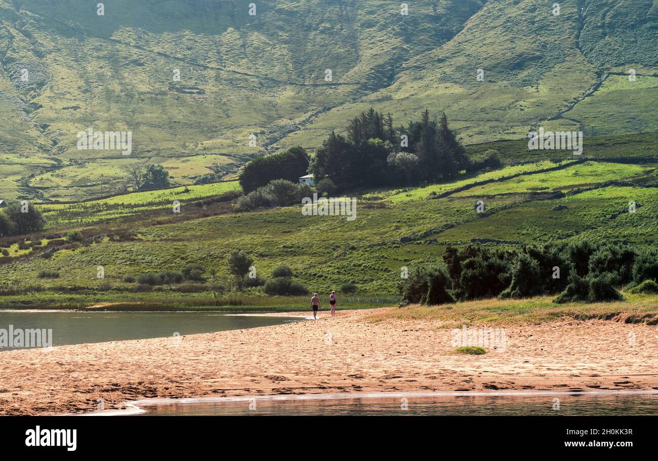Beautiful landscape scenery of sandy beach and green hills in the background at Loch na fooey in connemara National park in county Galway, Ireland Stock Photo
