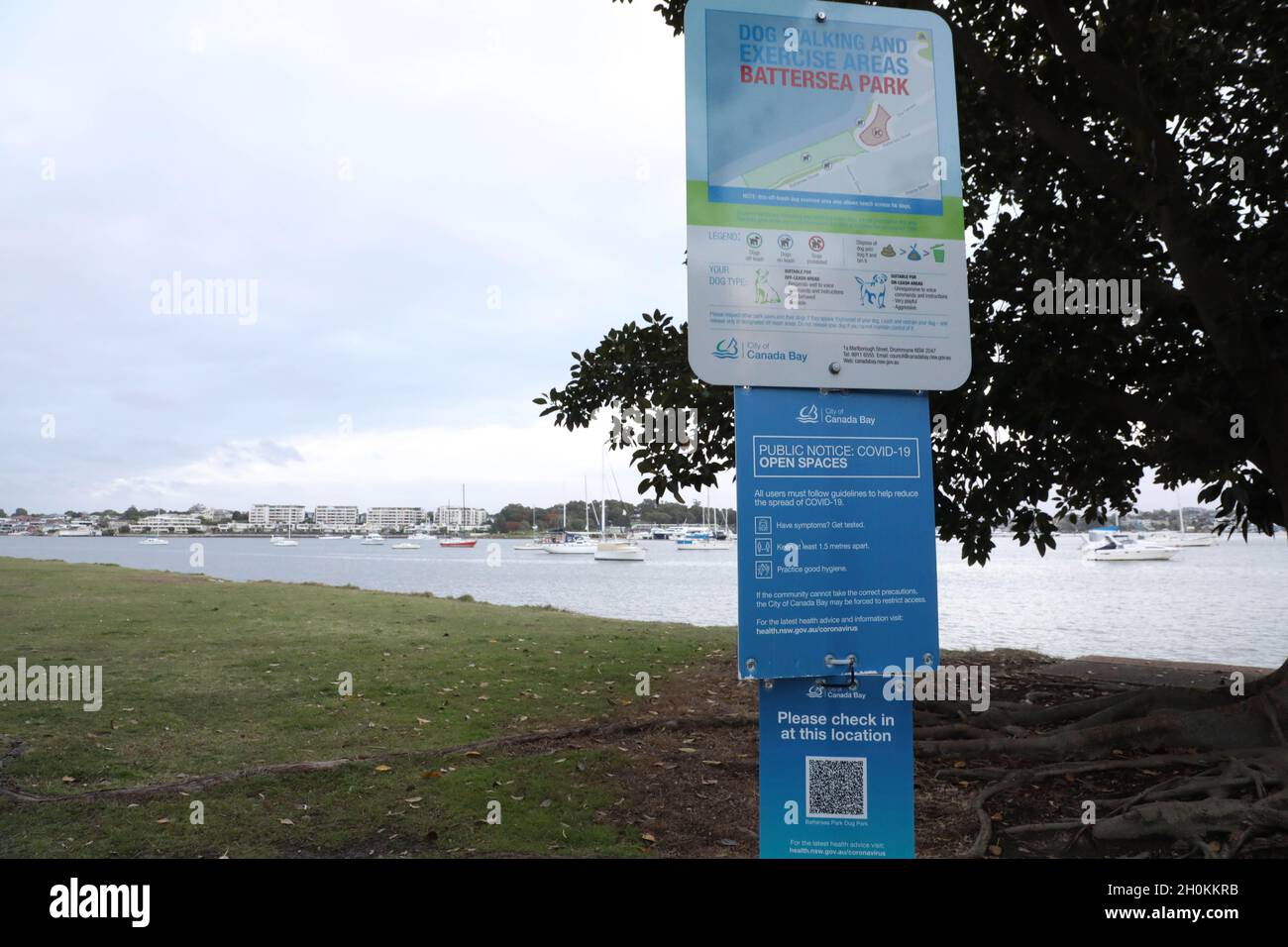 Sydney, Australia. 13th October 2021. Pictured: City of Canada Bay council Covid-19 sign and QR code check in at Battersea Park, Abbotsford next toteh Parramatta River. So called ‘freedom day’ was on 11th October as places in New South Wales open up only to the vaccinated and a system of segregation and apartheid is introduced. About 75% of the population who are fully vaccinated will be allowed inside various venues, but the other 25% who are not fully vaccinated with two doses are kept out. Credit: Richard Milnes/Alamy Live News Stock Photo