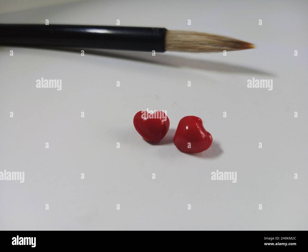china brush with red heart shape saga seeds Stock Photo