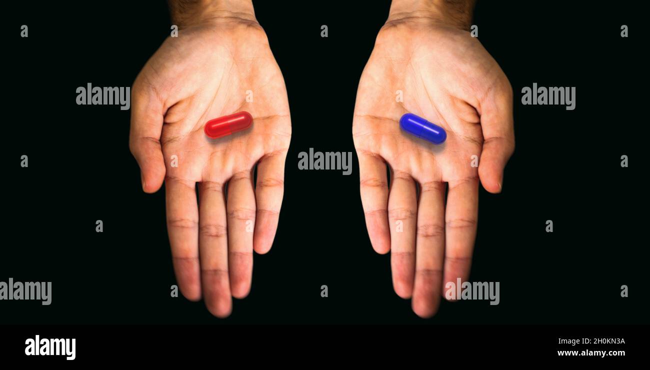 The red pill or the blue one? Opened hands with capsules in on black  background. One tablet in every palm the decision of the question for the  right h Stock Photo -