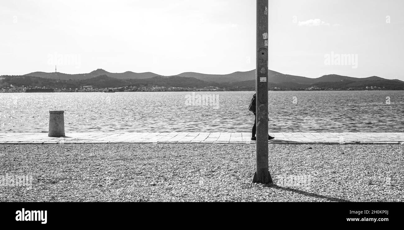 ZADAR, CROATIA Oct 07, 2021 A grayscale of a male tourist walking